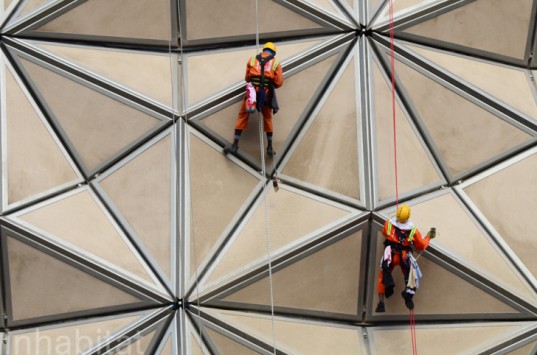 Construction workers on a buildings dynamic facade